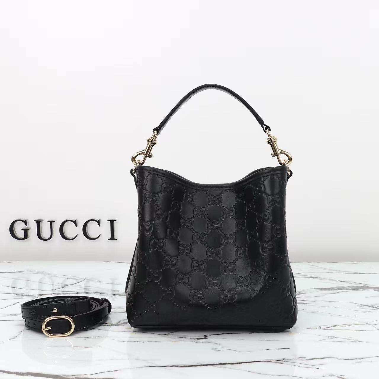 Gucci GG Emblem Small Bucket Bag in Black | GG Embossed Calfskin Leather with Adjustable Strap