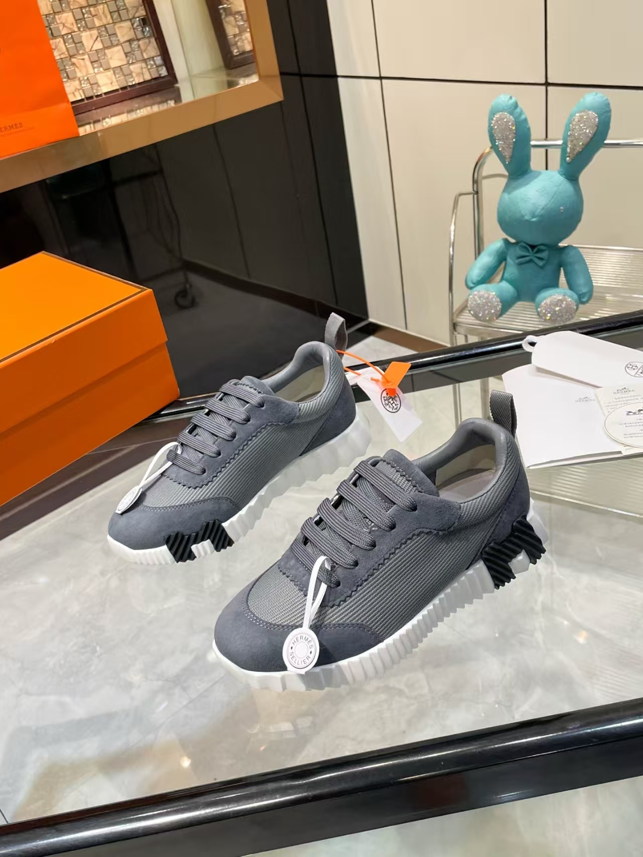 Hermès Sellier Knit Leisure Sneaker in White & Charcoal | Equestrian-Inspired Luxury Sport Shoe