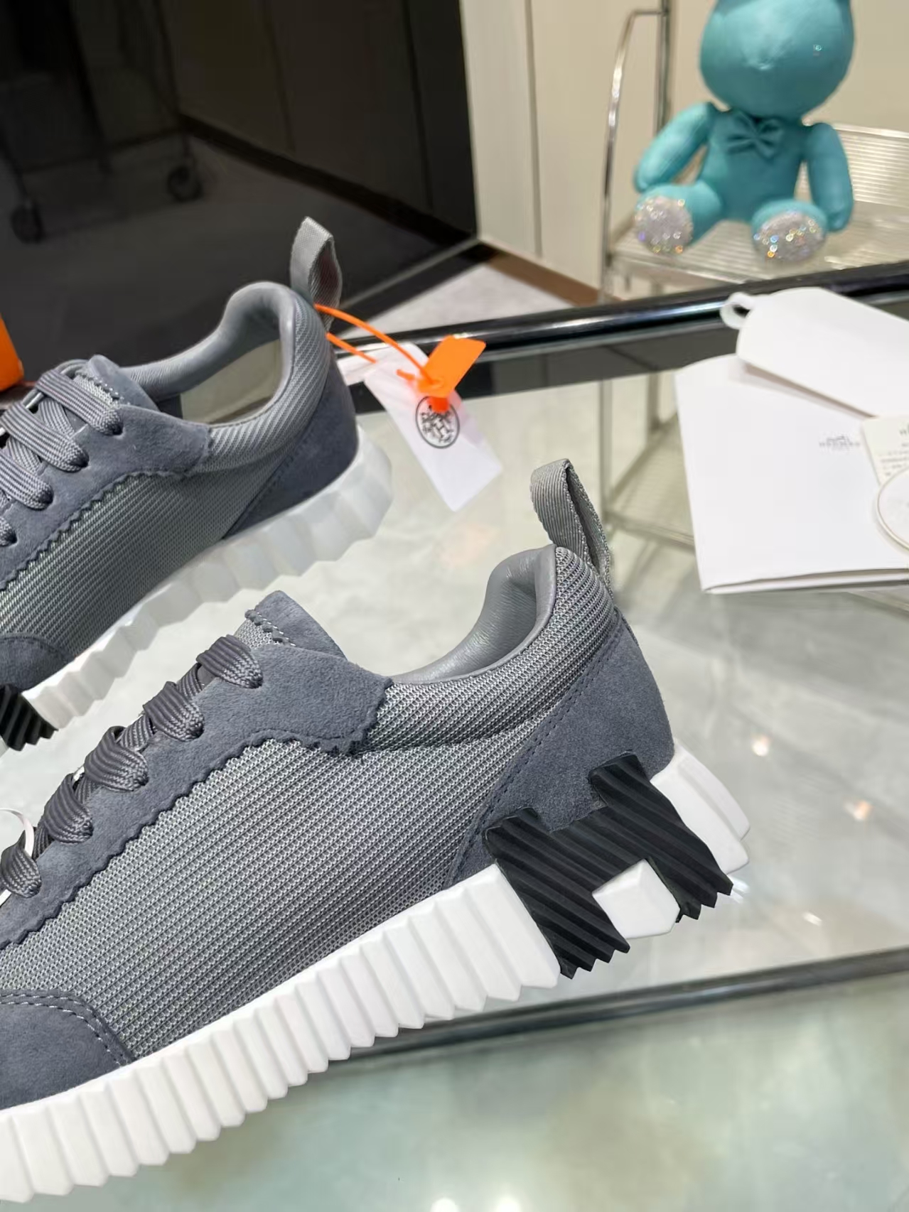 Hermès Sellier Knit Leisure Sneaker in White & Charcoal | Equestrian-Inspired Luxury Sport Shoe