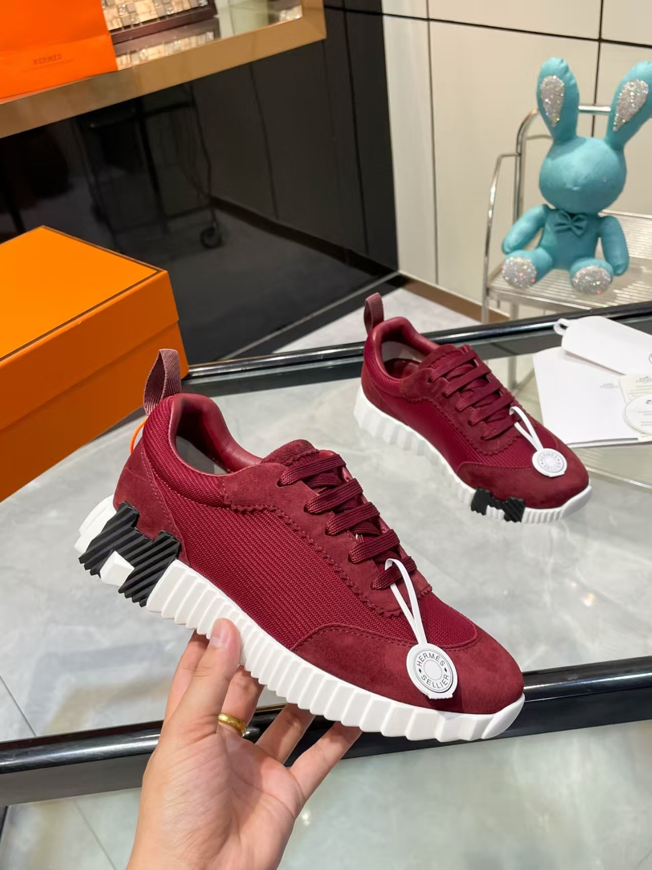 Hermès Sellier Knit Leisure Sneaker in White & Burgundy | Equestrian-Inspired Luxury Sport Shoe